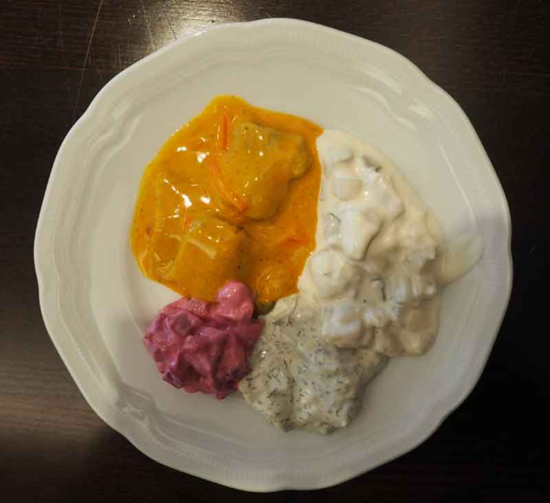 maatjes with currey sauce, beetroot, dill sauce, and with cucumber
