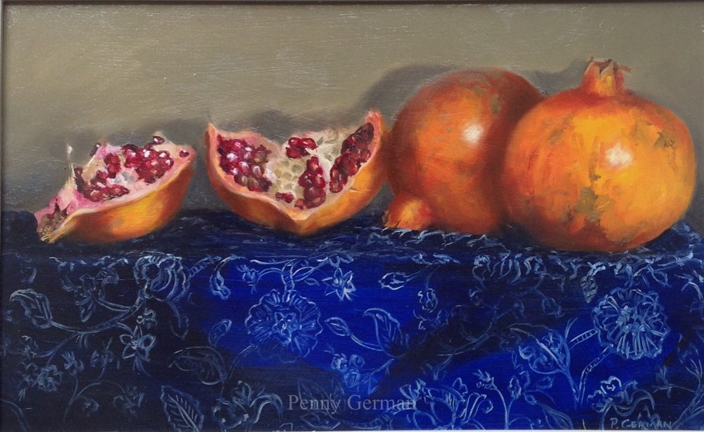 Complementary colours - indigo tablecloth against orange pomegranates