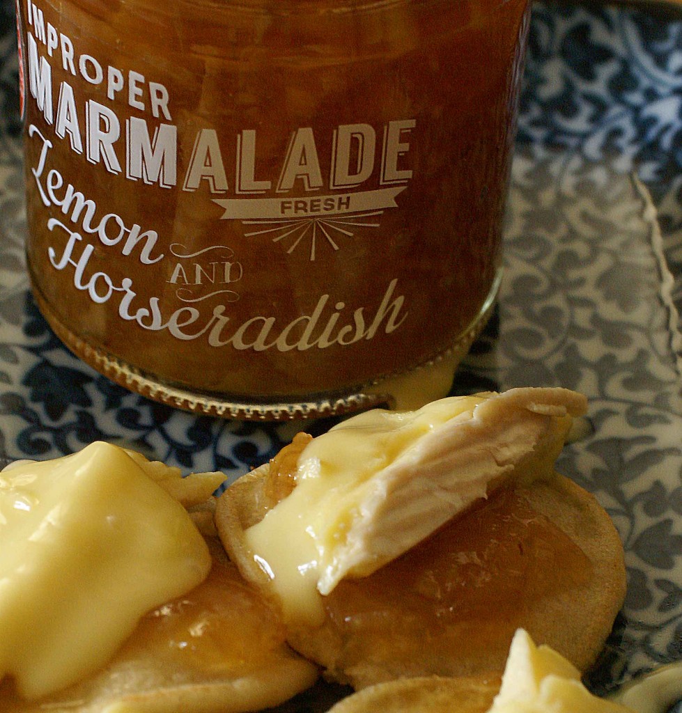 Improper lemon and horseradish marmelade with Waterloo cheese on blini